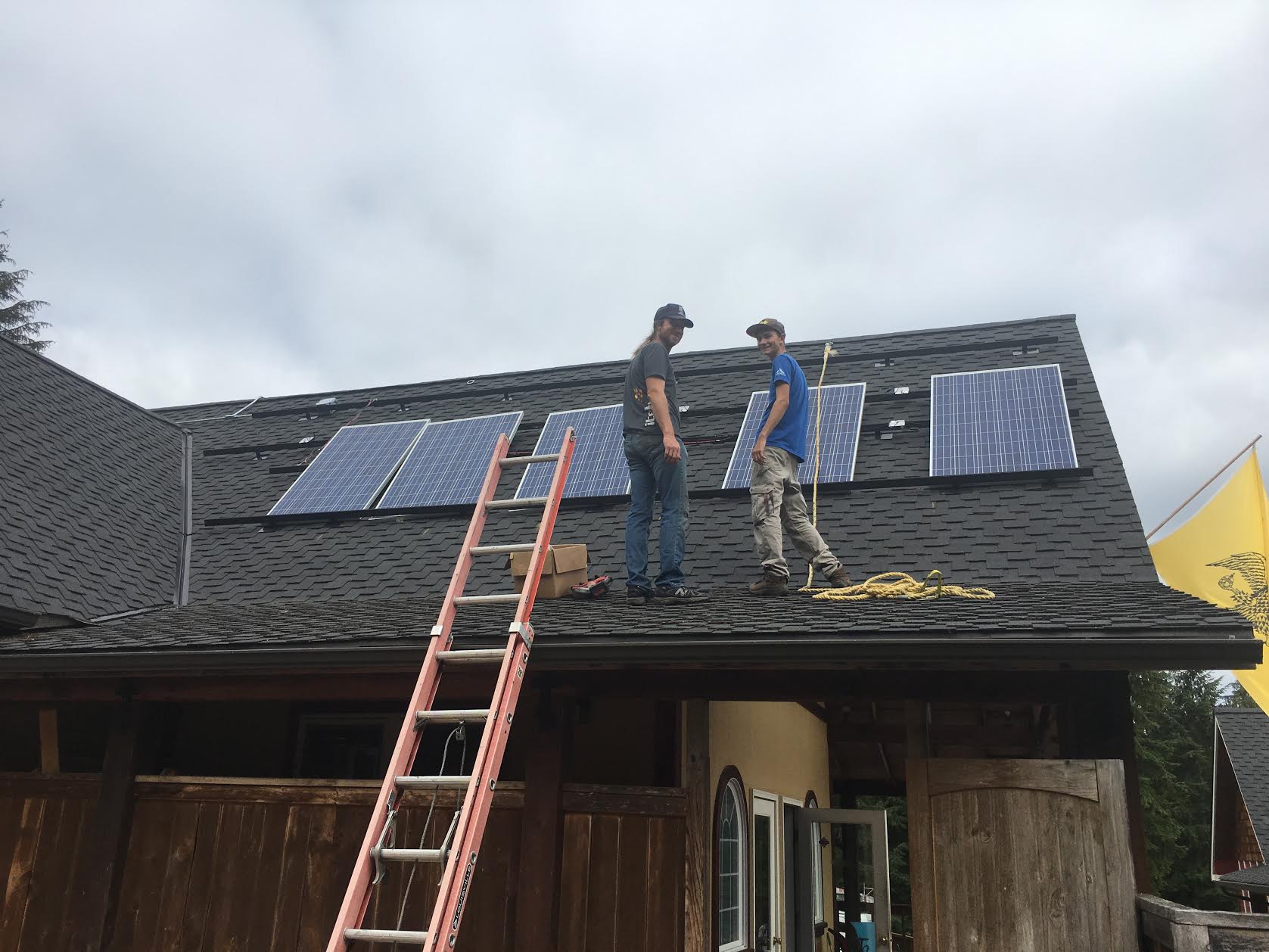 Artisan Electric solar contractors installing solar panels on monastery roof